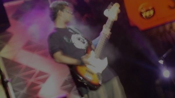 Nishal playing bass on stage