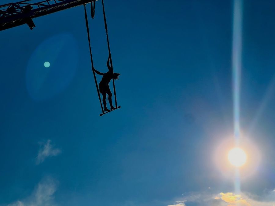 Acrobat silhouette against the sun