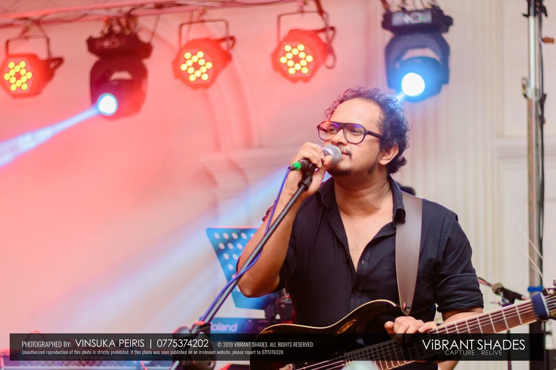 Nishal singing and playing guitar on stage